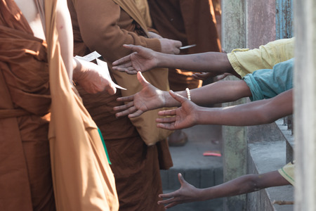 Poor people and human poverty concept - person hands begging for food or helpの写真素材