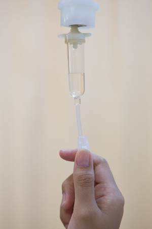 Nurse adjusting IV drip rateの写真素材