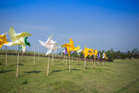 Toy windmill concept of green energy wind farm in fieldの写真素材