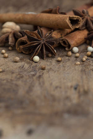 Spices lying on a wooden surface closeupの写真素材