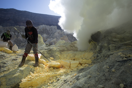 KAWAH IJEN, INDONESIA - OCT 12: Worker at sulfur mine inside Ijen crater on October 12, 2015. Miners are extracting gaseous sulfur going out in the mine of the craterのeditorial素材