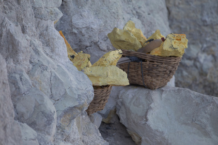 Baskets with sulphur at Kawah Ijen volcano crater, Java, Indonesiaの写真素材