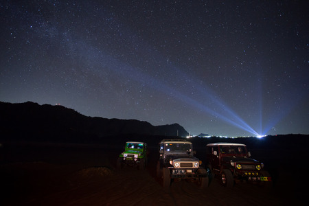 BROMO, INDONESIA - oct 12: Unidentified 4x4 Jeep for rent among the Milky way over the bromo volcano on october 12,2015 in Java, Indonesia. Mount Bromo is one of the most visited tourist attractionsのeditorial素材