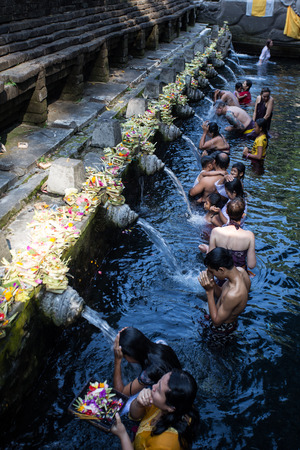 BALI ,INDONESIA - OCTOBER 10, 2015 : Travellers praying and take a bath at holy spring water at Tirta Empul Hindu Temple Bali ,Indonesia.のeditorial素材