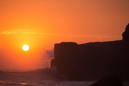 sunset over hindu temple Pura Tanah Lot, Bali, Indonesia