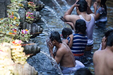 BALI ,INDONESIA - OCTOBER 10, 2015 : Travellers praying and take a bath at holy spring water at Tirta Empul Hindu Temple Bali ,Indonesia.のeditorial素材