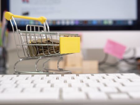 Shopping Cart With Coin On A Laptop Keyboard.の写真素材