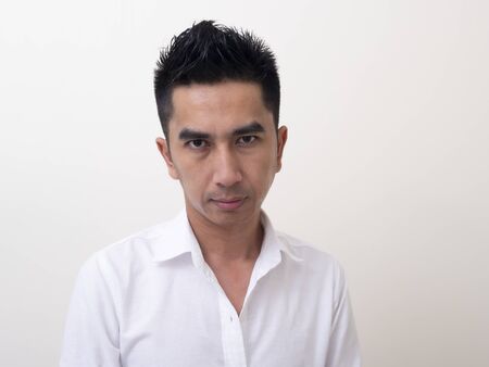 Portrait of smiling young man wearing white  shirtの写真素材