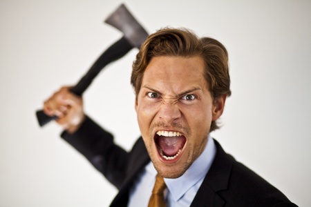Caucasian businessman with a axe cutting costs or giving someone the axe.の写真素材