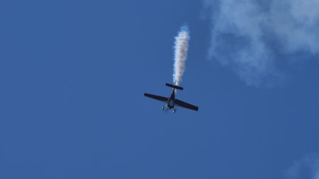 Maribor Airshow Slovenia AUGUST, 15, 2021 Aerobatic plane dives vertically in the blue sky. Copy space.. MX Aircraft MXS by Veres Zoltanのeditorial素材