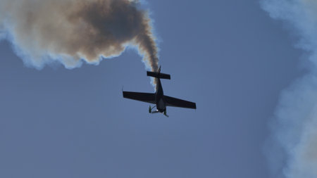 Maribor Airshow Slovenia AUGUST, 15, 2021 Black silhouette of an aerobatic plane descending...