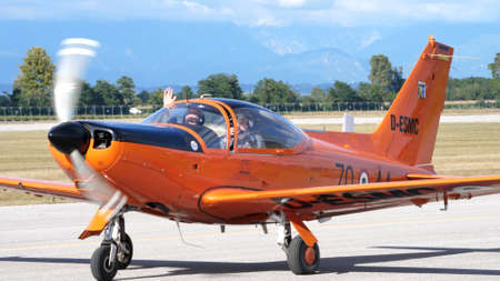 Rivolto del Friuli, Udine, Italy SEPTEMBER, 17, 2021 High performance low-wing propeller plane for training in orange taxiing with instructor and pickup on board. SIAI Marchetti SF-260のeditorial素材