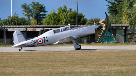 Rivolto del Friuli, Udine, Italy SEPTEMBER, 17, 2021 Tailwheel undercarriage grey two seats in tandem airplane side view on the runway. Fiat G.46 ex Italian Air Forceのeditorial素材
