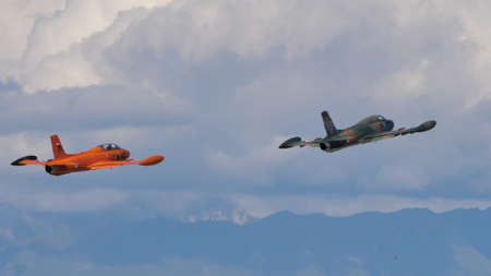 Rivolto Italy SEPTEMBER, 18, 2021 Two vintage military jet aircrafts of the cold war take off in formation. Aermacchi or Macchi MB-326K and an MB-326のeditorial素材