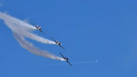 Thiene Italy OCTOBER, 16, 2021 Acrobatic planes in formation with smoke during an airshow in blue...