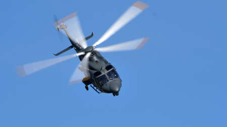 Thiene Italy, OCTOBER, 16, 2021 Modern NATO military helicopter in flight in the blue sky....