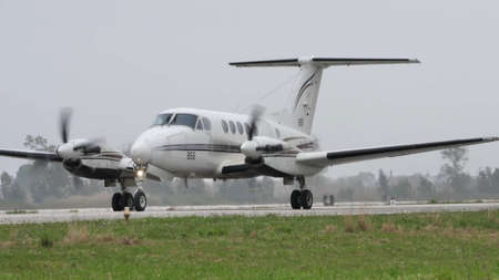 Andravida Greece APRIL, 1, 2022 Twin engine turboprop airplane taxiing on the military base runway...