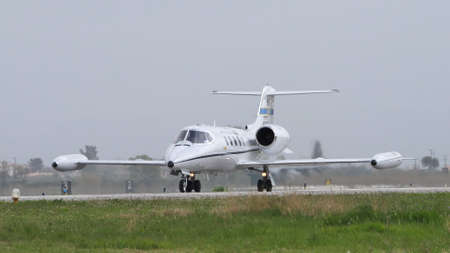 Andravida Greece APRIL, 1, 2022 Modern executive business jet of United Stated air force taxiing on the airport runway. Gates Learjet 35 C-21A of USAF used for passenger and cargo transportationのeditorial素材