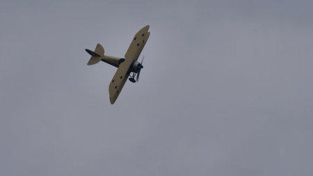 Zeltweg, Austria SEPTEMBER, 6, 2019 Vintage biplane of First World War WWI in grey heavy rain cloudy sky. FVM CVM O1 Tummelisa propeller plane of Swedish Air Force. Copy space.のeditorial素材