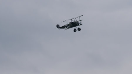 Zeltweg, Austria SEPTEMBER, 6, 2019 Vintage biplane of First World War WWI in grey heavy rain cloudy sky. FVM CVM O1 Tummelisa propeller plane of Swedish Air Force. Copy space.のeditorial素材