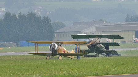 Zeltweg, Austria SEPTEMBER, 6, 2019 Vintage biplane of First World War WWI in grey heavy rain cloudy sky. FVM CVM O1 Tummelisa propeller plane of Swedish Air Force. Copy space.のeditorial素材