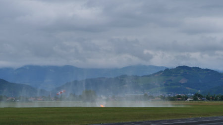 Cerklje Slovenia MAY 29, 2022 Water dropped from a helicopter over a forest fire. Eurocopter AS532 Cougar, Airbus Helicopters H215M, of Slovenian Air Force. Copy spaceのeditorial素材