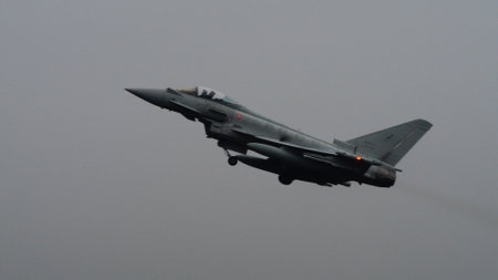 Istrana Italy December 13 2023: Showcasing resilience, a NATO supersonic defense aircraft patrols the grey skies on a day of bad weather, affirming airspace security regardless of conditions.のeditorial素材