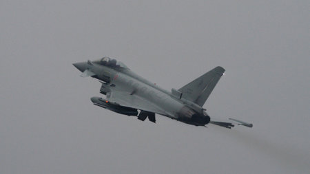 Istrana Italy December 13 2023: Showcasing resilience, a NATO supersonic defense aircraft patrols the grey skies on a day of bad weather, affirming airspace security regardless of conditions.のeditorial素材