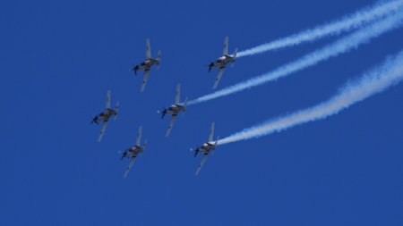 Pula Croatia March 23 2024: Flawless formation of military propeller planes with trailing smoke against a clear blue skyのeditorial素材