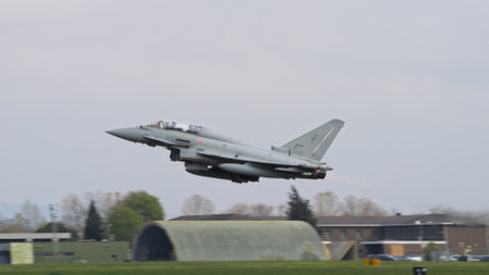 Istrana Italy April 5 2024: NATO Combar Aircraft at Low Altitude After Take Off from a Military Airport. Eurofighter Typhoon of Italian Air Force. Copy Space.のeditorial素材