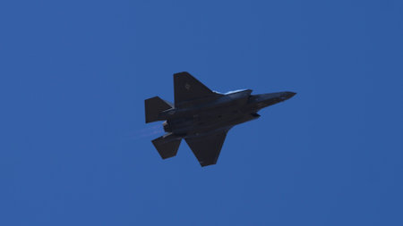Athens Greece September 3 2023: Stealth jet combat aircraft in flight against a clear blue sky. Copy Space. Lockheed Martin F-35 Lightning II of United States Air Force.のeditorial素材