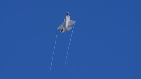 Athens Greece September 3 2023: Combat jet aircraft climbing vertically with contrails against clear blue sky. Copy Space. Lockheed Martin F-35 Lightning II of United States Air Force.のeditorial素材