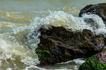 Stones and sea waves. Rocks in sea waves. Splashes of sea waves.の写真素材
