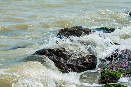 Stones and sea waves. Rocks in sea waves. Splashes of sea waves.の写真素材