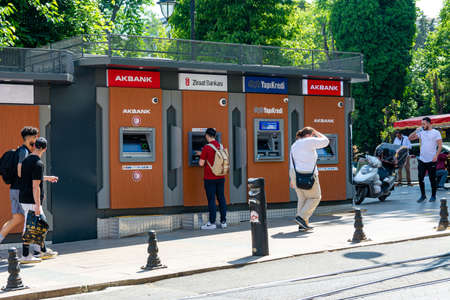 Turkey, Istanbul 06/02/2022: ATMs of various banks on a busy street of the metropolis. People withdraw cash and go somewhere down the street.のeditorial素材