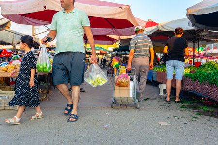 Antalya, Turkey 08.13.2022: Bazaar in the Turkish city near Alanya, people buy groceries, vegetables, fruits. Many people at the market choose and buy food on a sunny summer day. Turks in the market.のeditorial素材