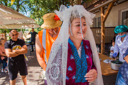 Pyryatyn, Ukraine 08.28.2020: wedding celebration in a Ukrainian provincial town. they drink alcohol, have fun, laugh. Traditional Ukrainian wedding with costumes for guests and bride price.のeditorial素材