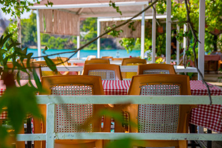 Tables and chairs on the summer terrace of the restaurant. Simple plastic furniture of the restaurant in the resort region of Turkey.の写真素材