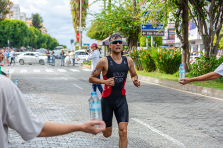 Alanya, Turkey, 10/16/2022: Man athlete from Turkey runs a marathon through the streets of the Alanya city in Turkey. 2022 Europe Triathlon Cup Alanya, Run Course.のeditorial素材