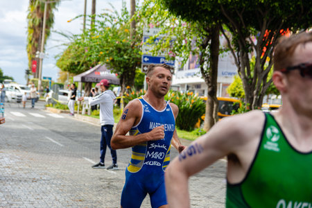 Alanya, Turkey, 10/16/2022: Man athlete from Ukraine runs a marathon through the streets of the Alanya city in Turkey. 2022 Europe Triathlon Cup Alanya, Run Course.のeditorial素材