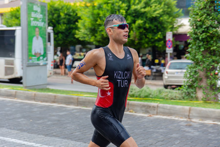Alanya, Turkey, 10/16/2022: Man athlete from Turkiye runs a marathon through the streets of the Alanya city in Turkey. 2022 Europe Triathlon Cup Alanya, Run Course.のeditorial素材