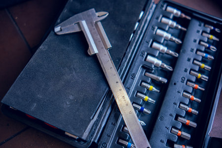 The calipers is lying on the toolbox. Technical tools close-up. Equipment for car repair in the workshop.の写真素材