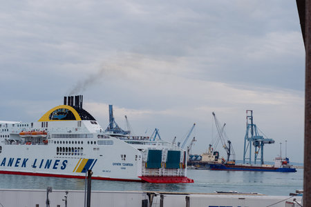 Ancona Italy - 20 Sep 2023: View of the port with many port cranes and a huge liner entering the port.のeditorial素材