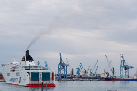 Ancona Italy - 20 Sep 2023: View of the port with many port cranes and a huge liner entering the port.のeditorial素材