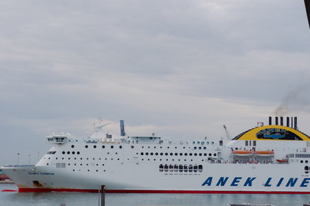 Ancona Italy - 20 Sep 2023: View of the port with many port cranes and a huge liner entering the port.のeditorial素材