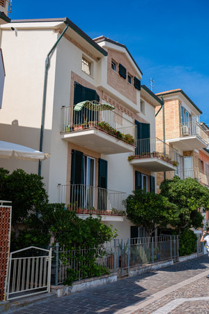 Washed clothes hang from the balcony and dry outside. Street of the Italian resort town. Clothes dry on the balcony.の写真素材