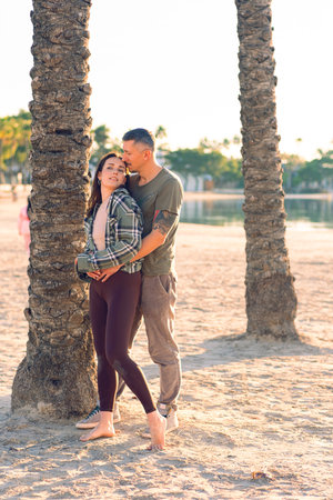 A couple in love hugs on the sea beach. A man and a woman enjoy each other and their vacation by the sea.の写真素材