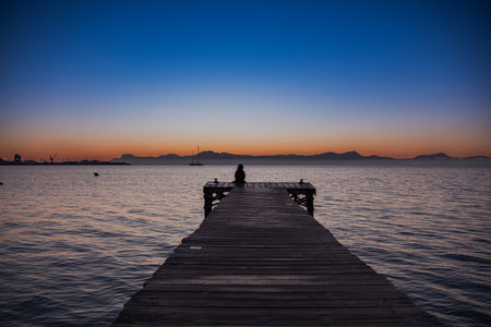 Old people swim in the sea. An elderly couple enjoys life by spending time at sea. An old grandfather and grandmother in a swimsuit are walking along the sea.の写真素材