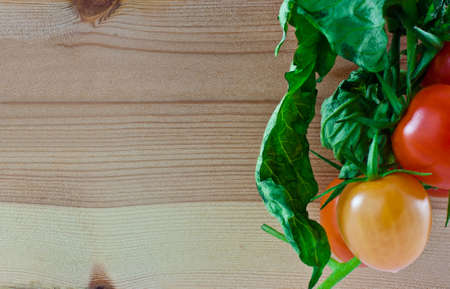 bunch of tomatoes on woodの写真素材