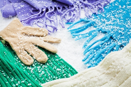 gloves and scarves of wool over the snow の写真素材